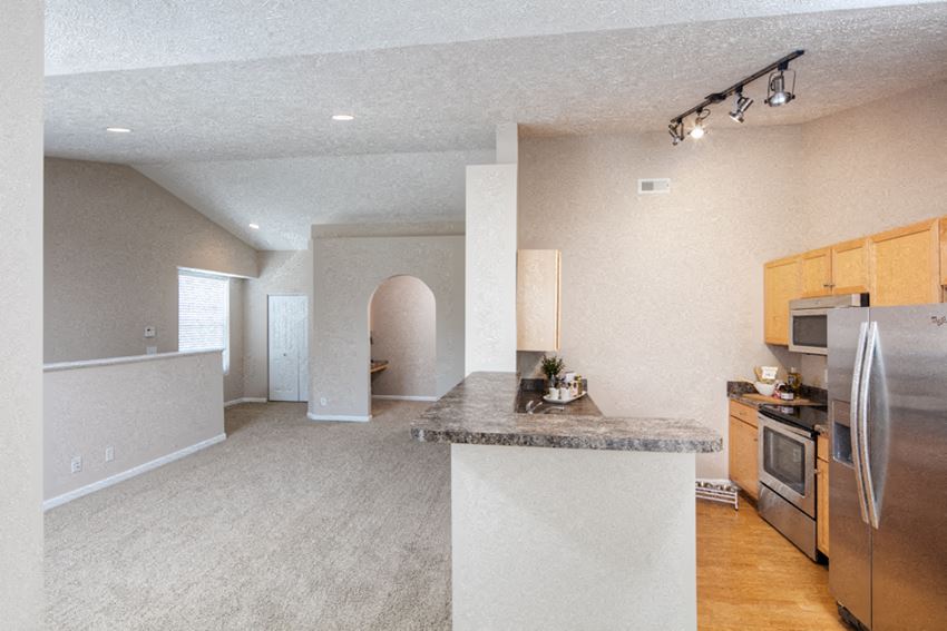 an open floor plan with a kitchen and living room