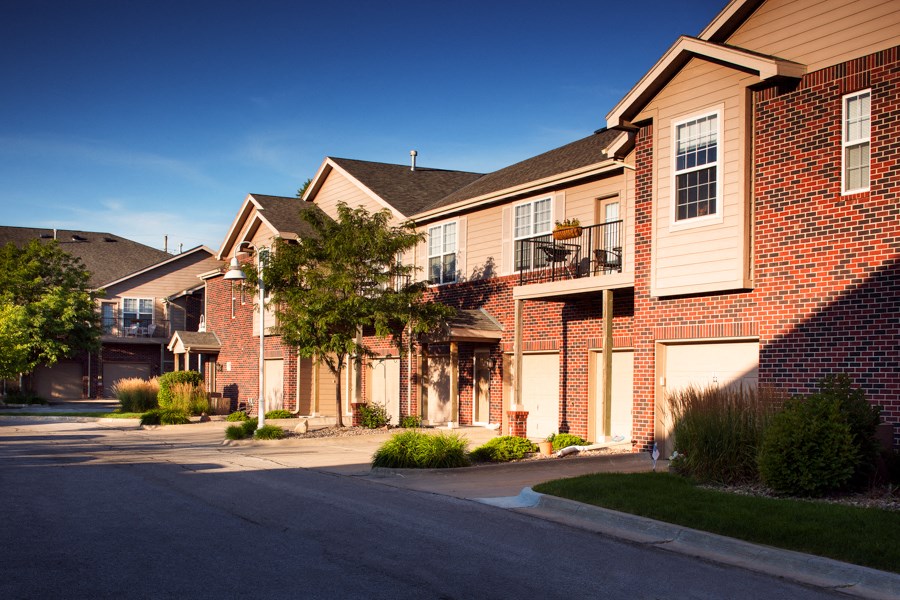 a row of brick homes on the side of a street