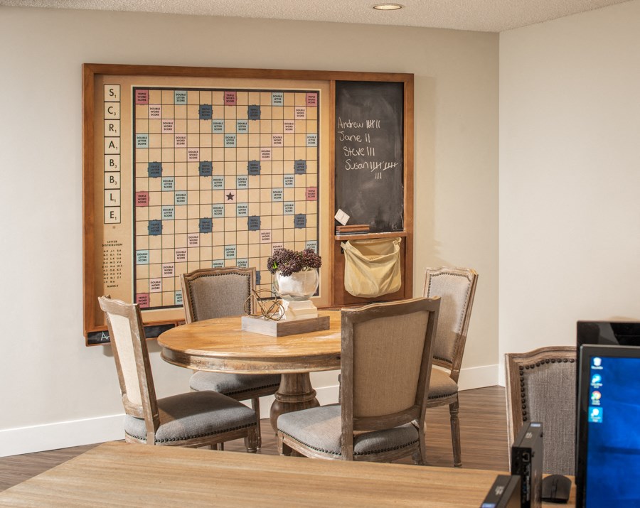 a dining room with a table and chairs and a bulletin board