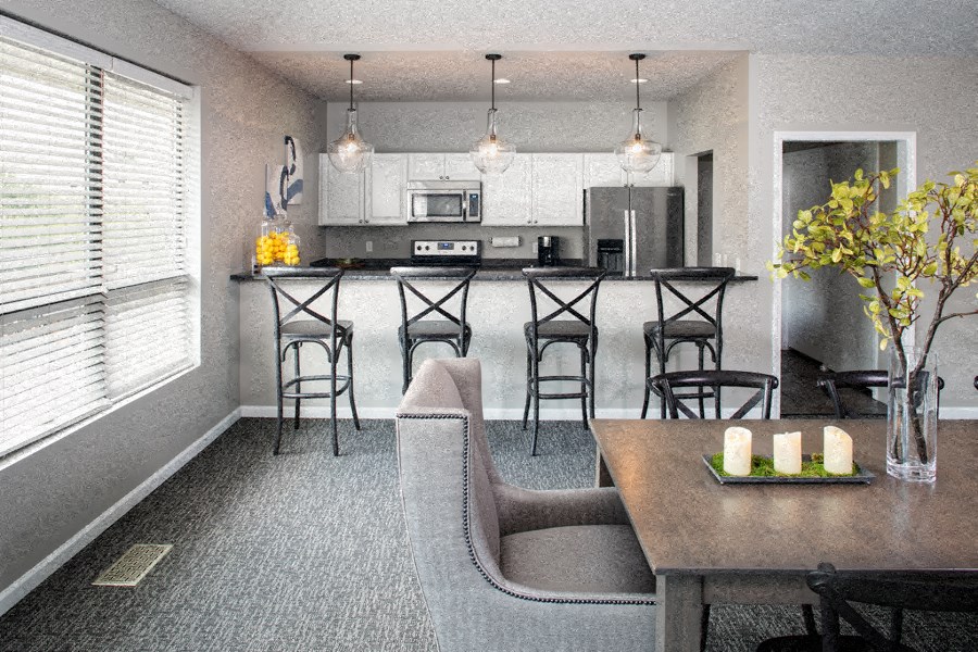a kitchen and dining room with a table and chairs