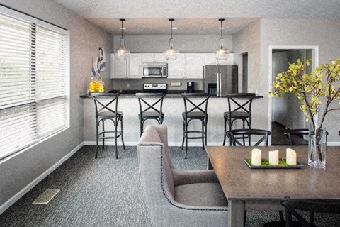 a kitchen and dining room with a table and chairs