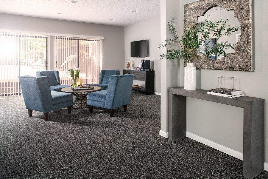 a living room with blue chairs and a table