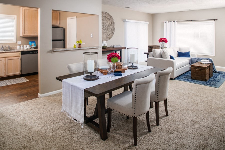 a living room and dining room with a table and chairs