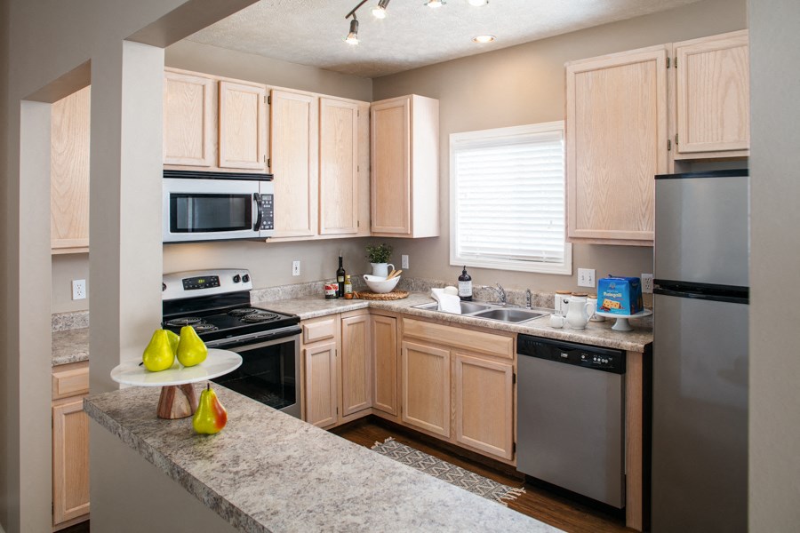 a kitchen with granite counter tops and stainless steel appliances