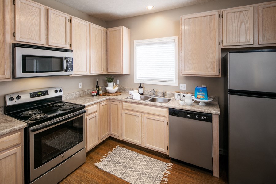 a kitchen with stainless steel appliances and wooden cabinets
