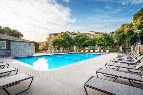 a swimming pool with rows of lounge chairs around it