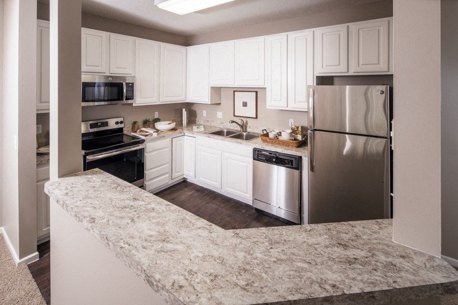 a kitchen with stainless steel appliances and granite counter tops