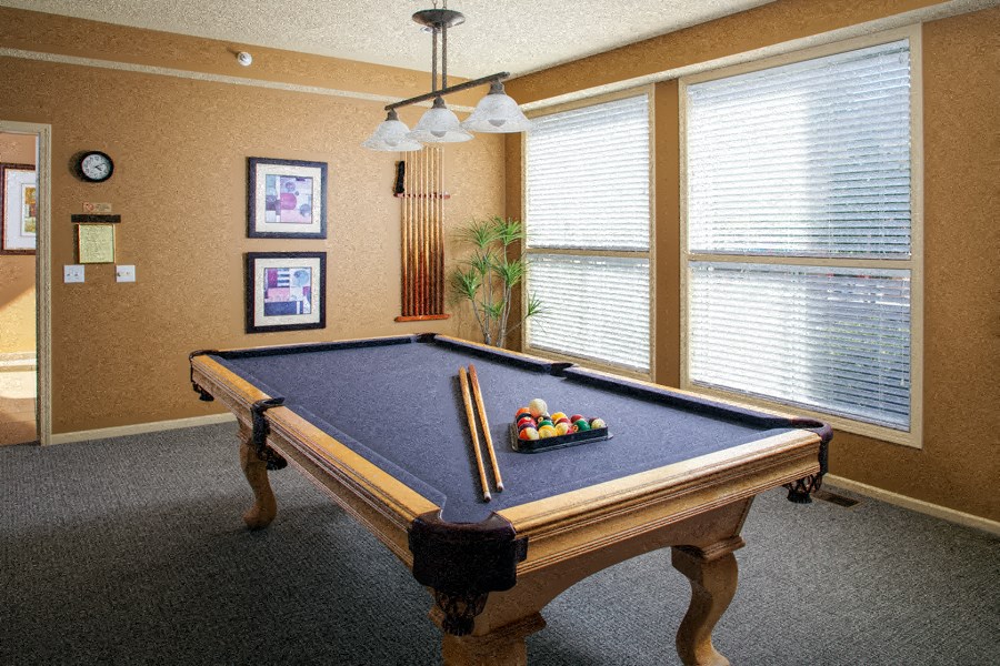 a pool table in a game room with a billiard