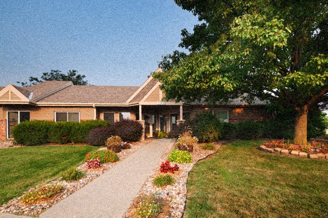 a house with a walkway and flowers in front of it