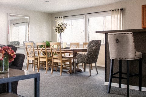 a dining room and living room with a table and chairs
