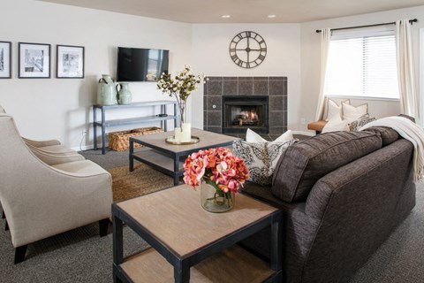 a living room with a couch and a coffee table and a fireplace