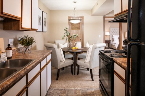 a kitchen and dining room with a table and chairs