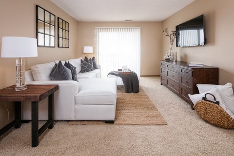 a living room with a white couch and a tv