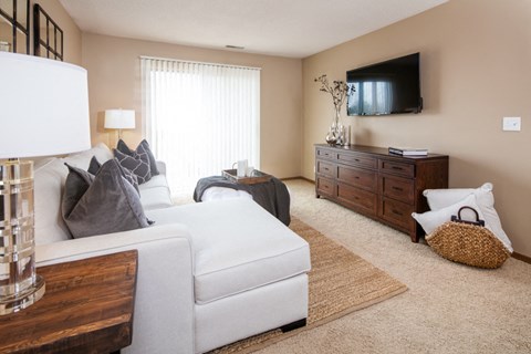 a living room with a white couch and a tv