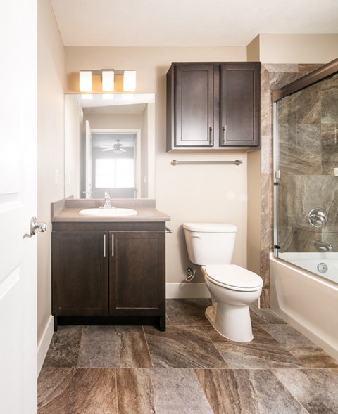 a bathroom with a toilet and a sink and a shower