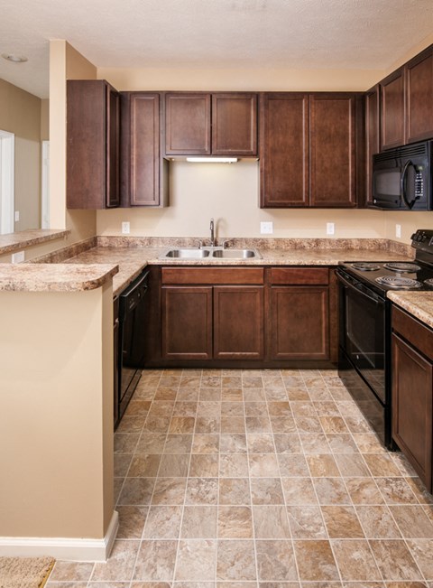 a kitchen with dark wood cabinets and a counter top