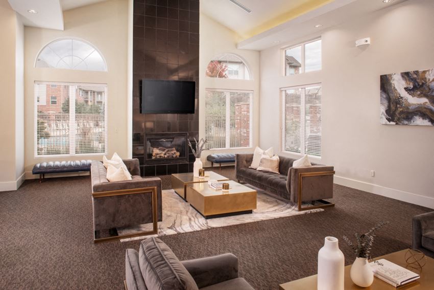 a living room with couches a coffee table and a fireplace