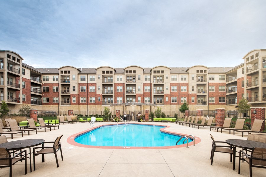 a swimming pool in front of an apartment building