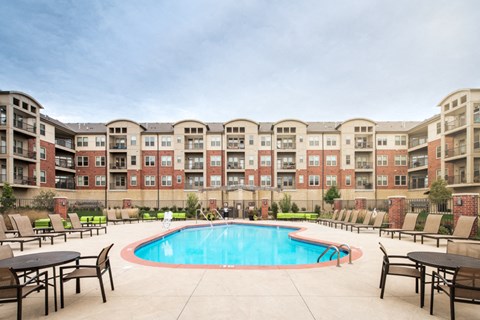 a swimming pool in front of an apartment building