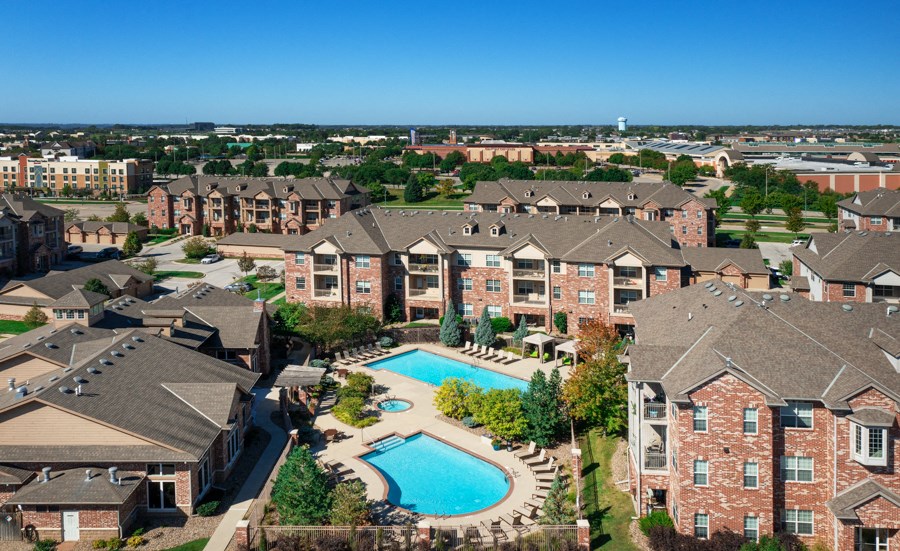an aerial view of an apartment complex with a swimming pool