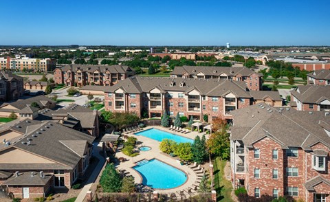 an aerial view of an apartment complex with a swimming pool