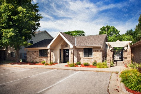 the front of a brick house with a driveway