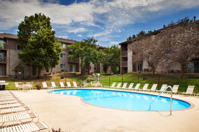 a swimming pool in front of an apartment building