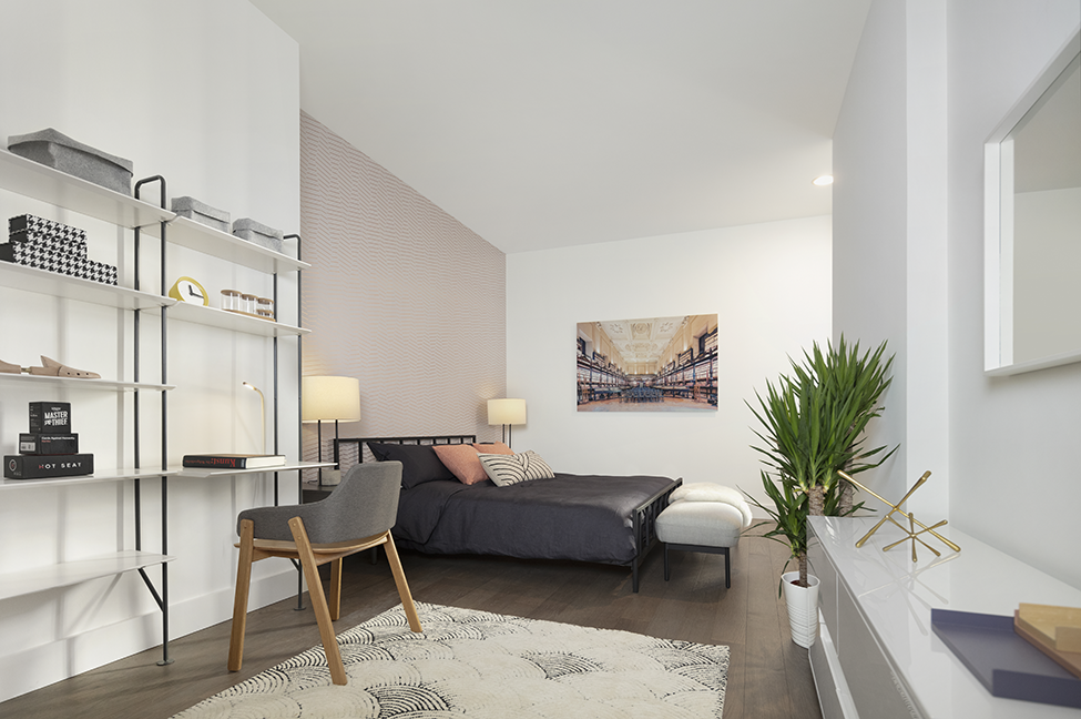 a living room with white walls and a black couch