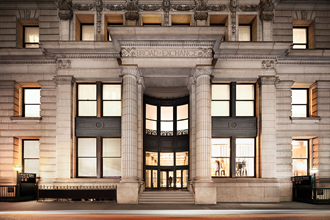 the facade of the school of exchange in philadelphia. the facade is tan with columns and
