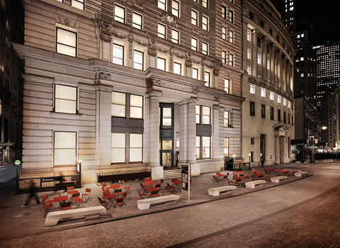 an outdoor seating area of a building in the city at night