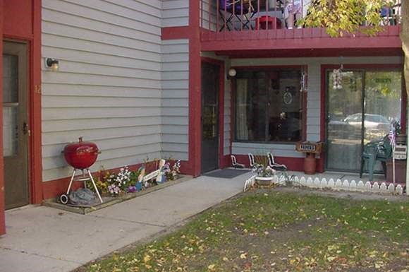 a house with a yard and a red door