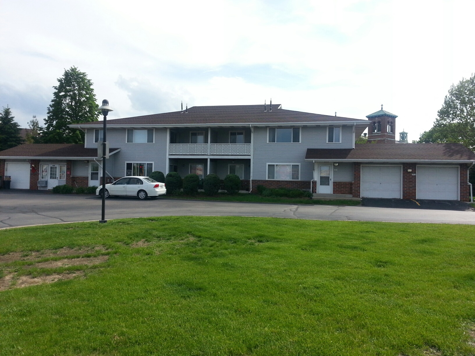 a house with a white car parked in front of it
