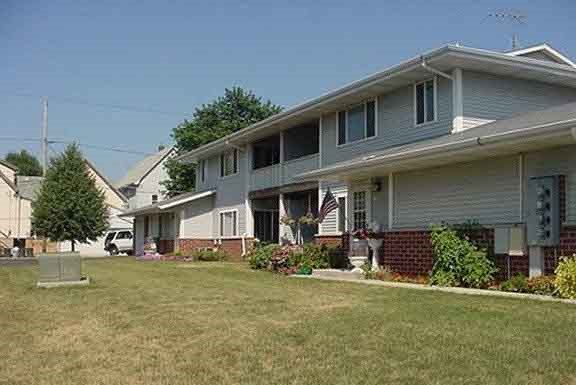 a white house with a yard in front of it