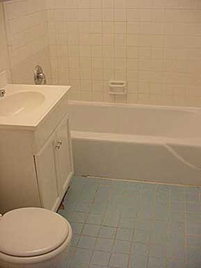 a bathroom with a toilet and a tub and a sink