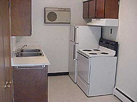 a small kitchen with a stove and a refrigerator