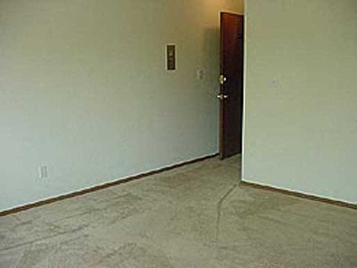 an empty room with a white wall and a door