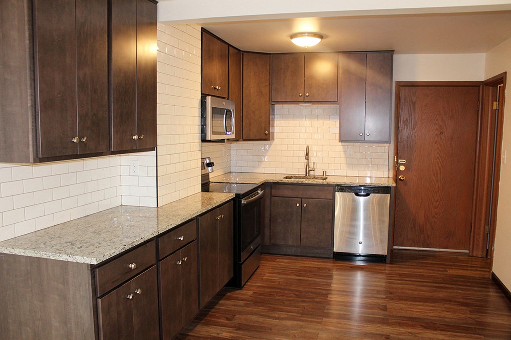 a kitchen with wooden cabinets and a stainless steel