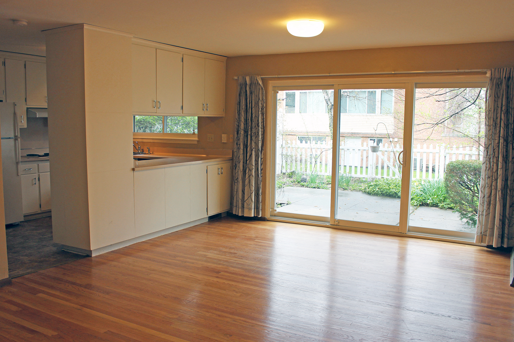 an empty kitchen with a sliding glass door to the yard