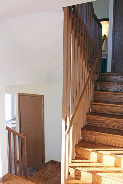 a wooden staircase in a house next to a door