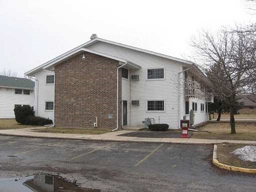 a white house with a red mailbox in front of it