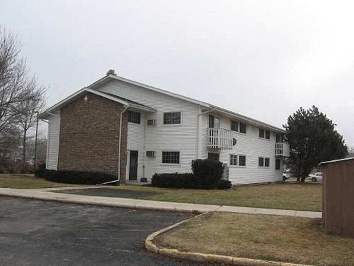 a white house on the side of a street
