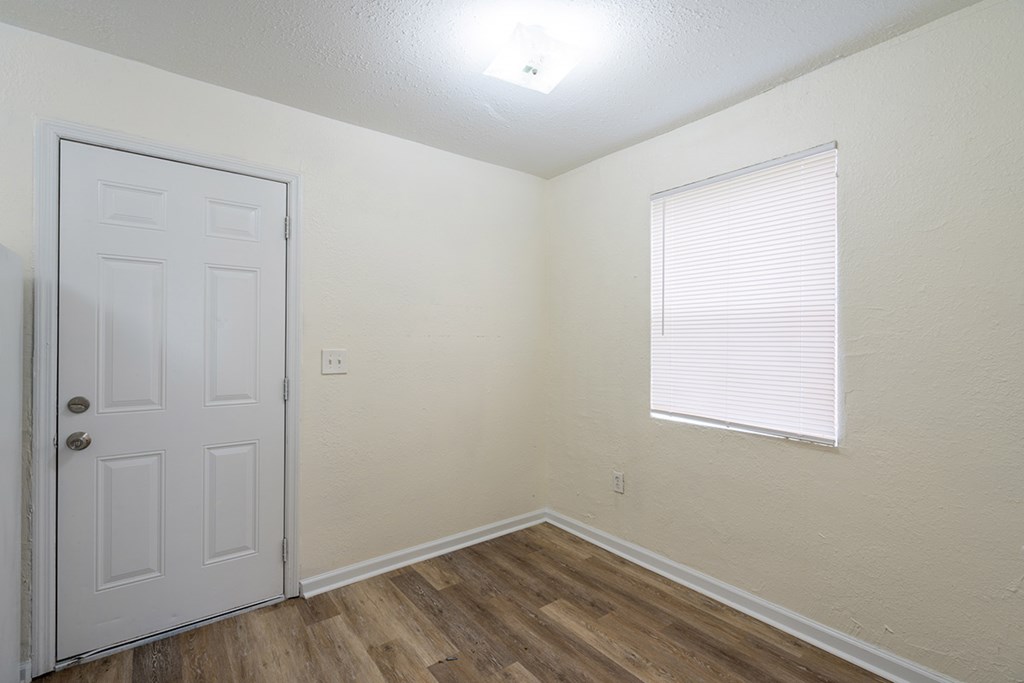 a bedroom with a white door and a window