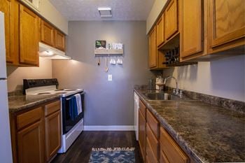 This is a photo of the light honey oak cabinets in the kitchen of a 2 bedroom apartment at Deer Hill Apartments in Cincinnati, OH.