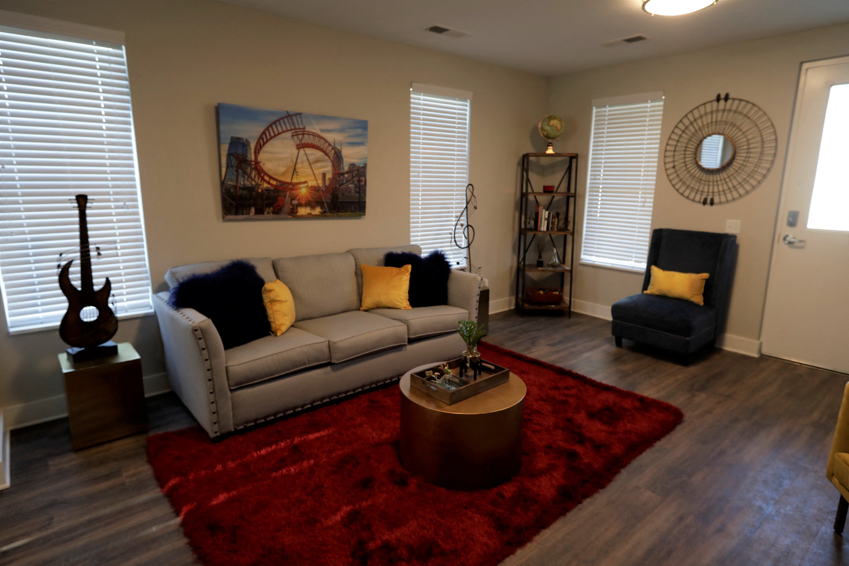a living room with a red rug and a couch