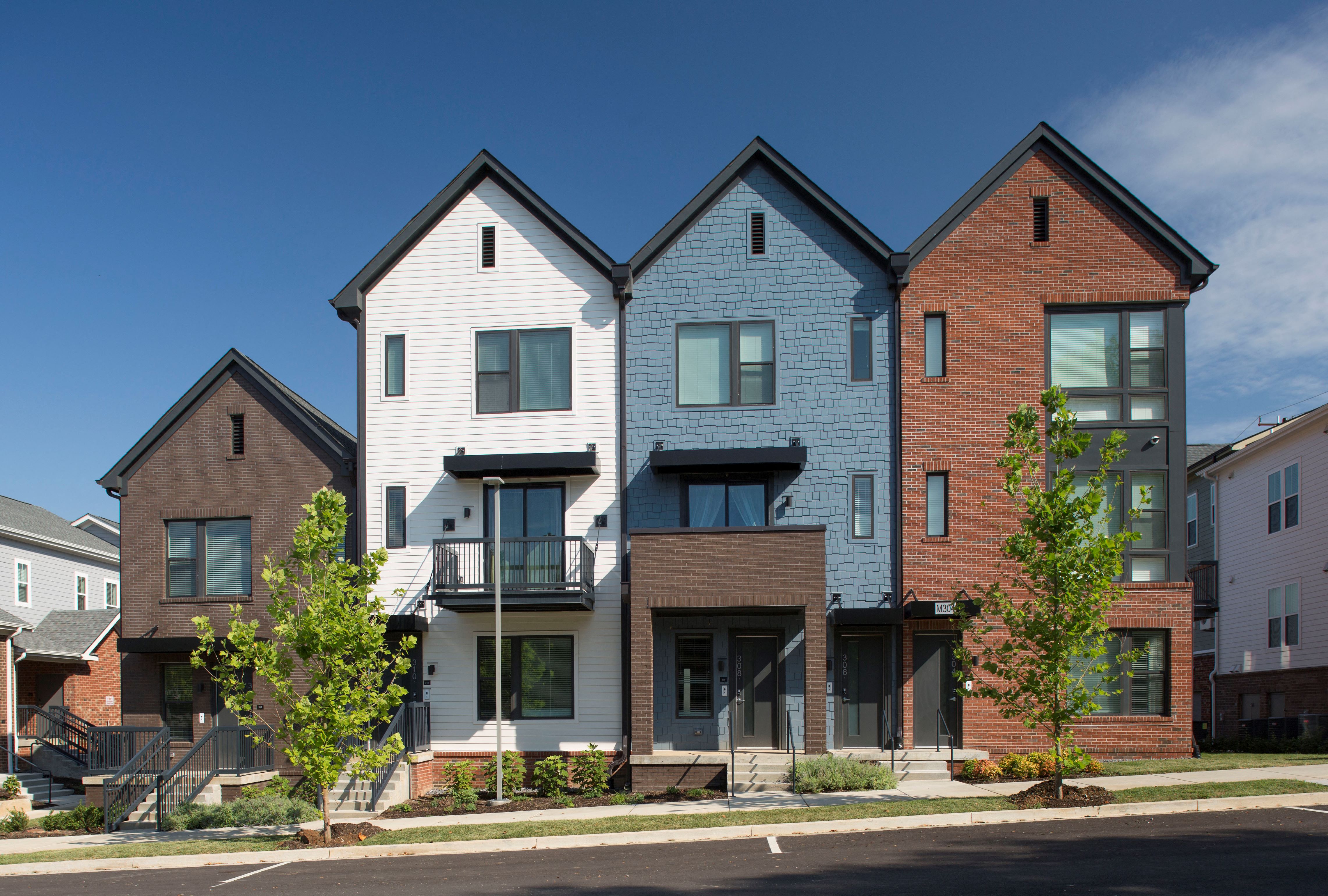 A row of houses with different colored exteriors.