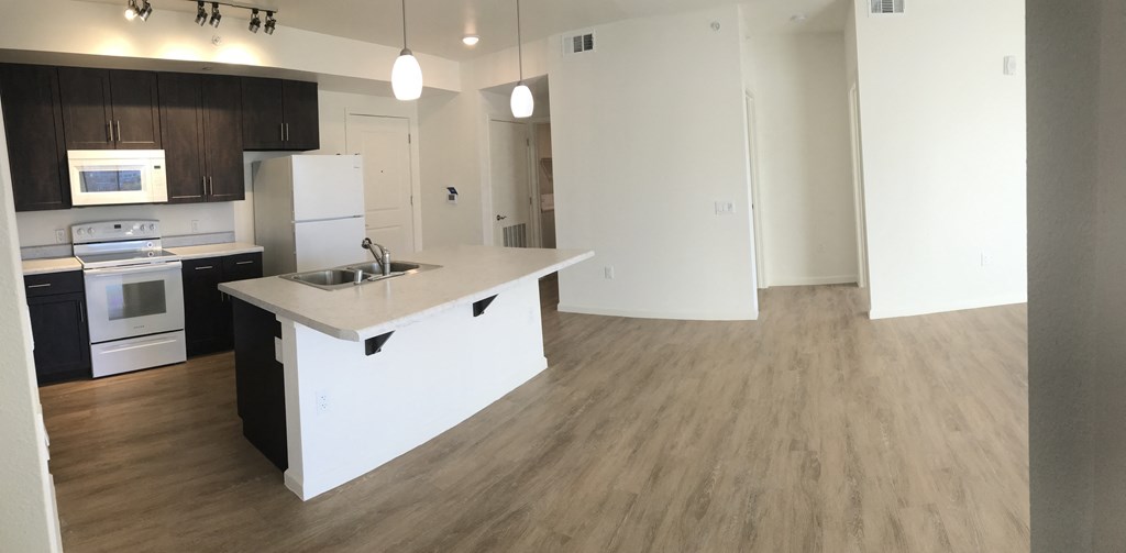 an empty kitchen with an island in the middle