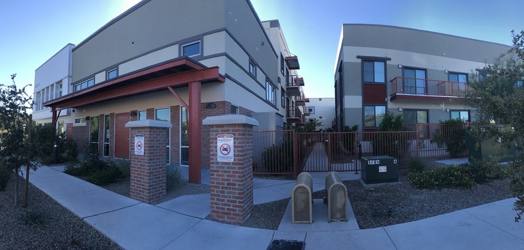 an apartment building with two parking meters in front of it