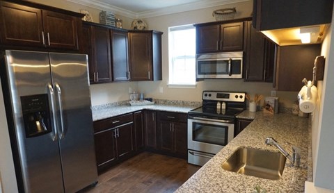 a kitchen with stainless steel appliances and granite counter tops