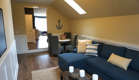 a living room with a blue couch and a table