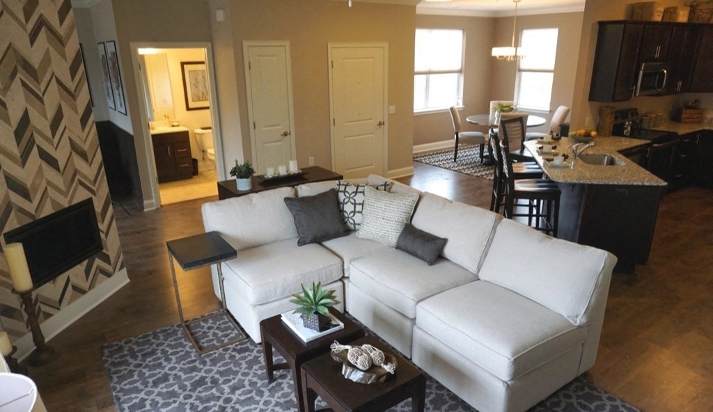 a living room with a white couch and a table